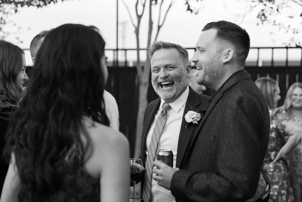 Wedding guests share candid laughs and joyful moments during an outdoor celebration at Lillian Gardens in Newnan, Georgia