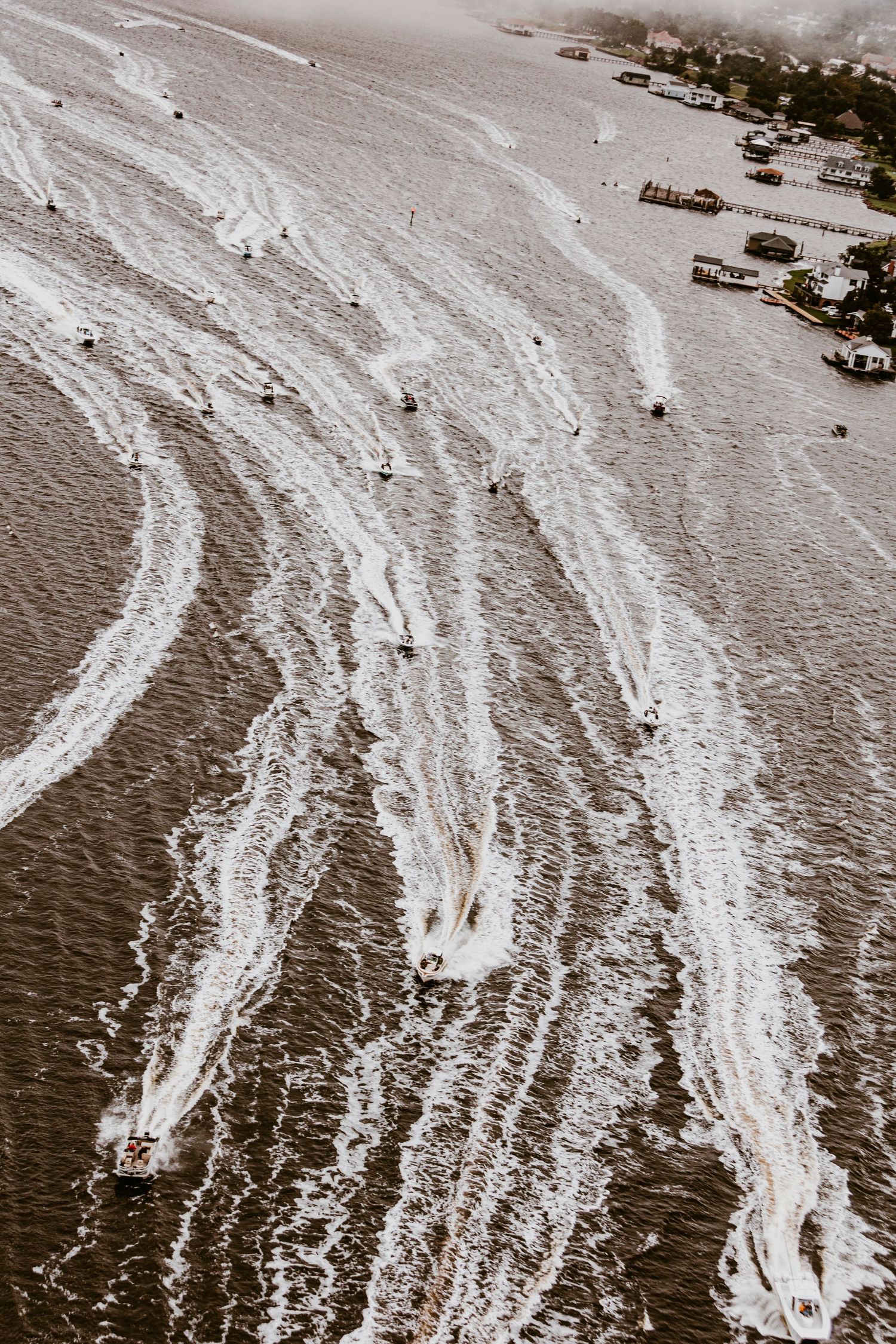 Vintage aerial photograph showing boats creating wake patterns across harbor waters.