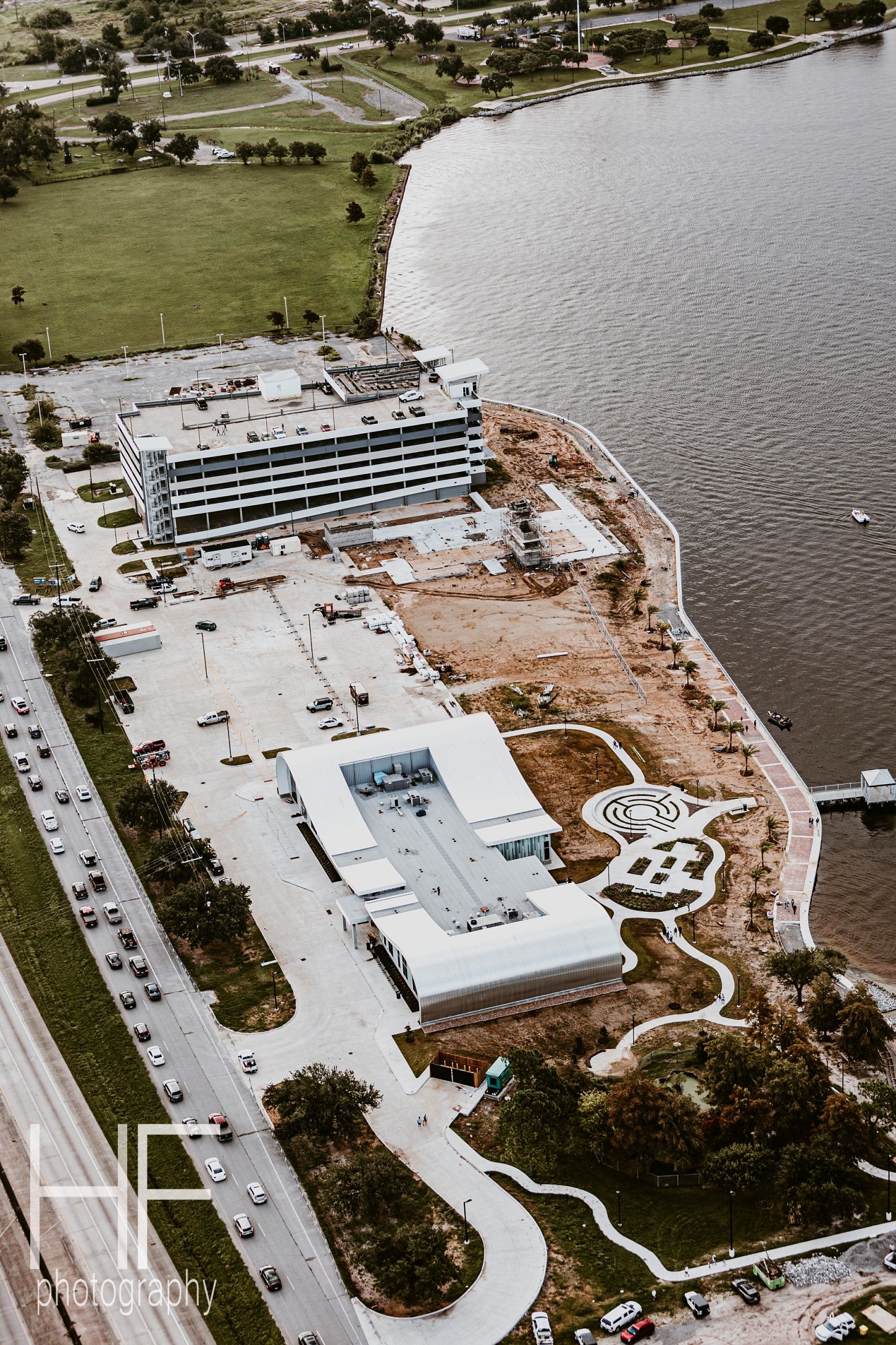Aerial view of a waterfront construction site showing building development phases.