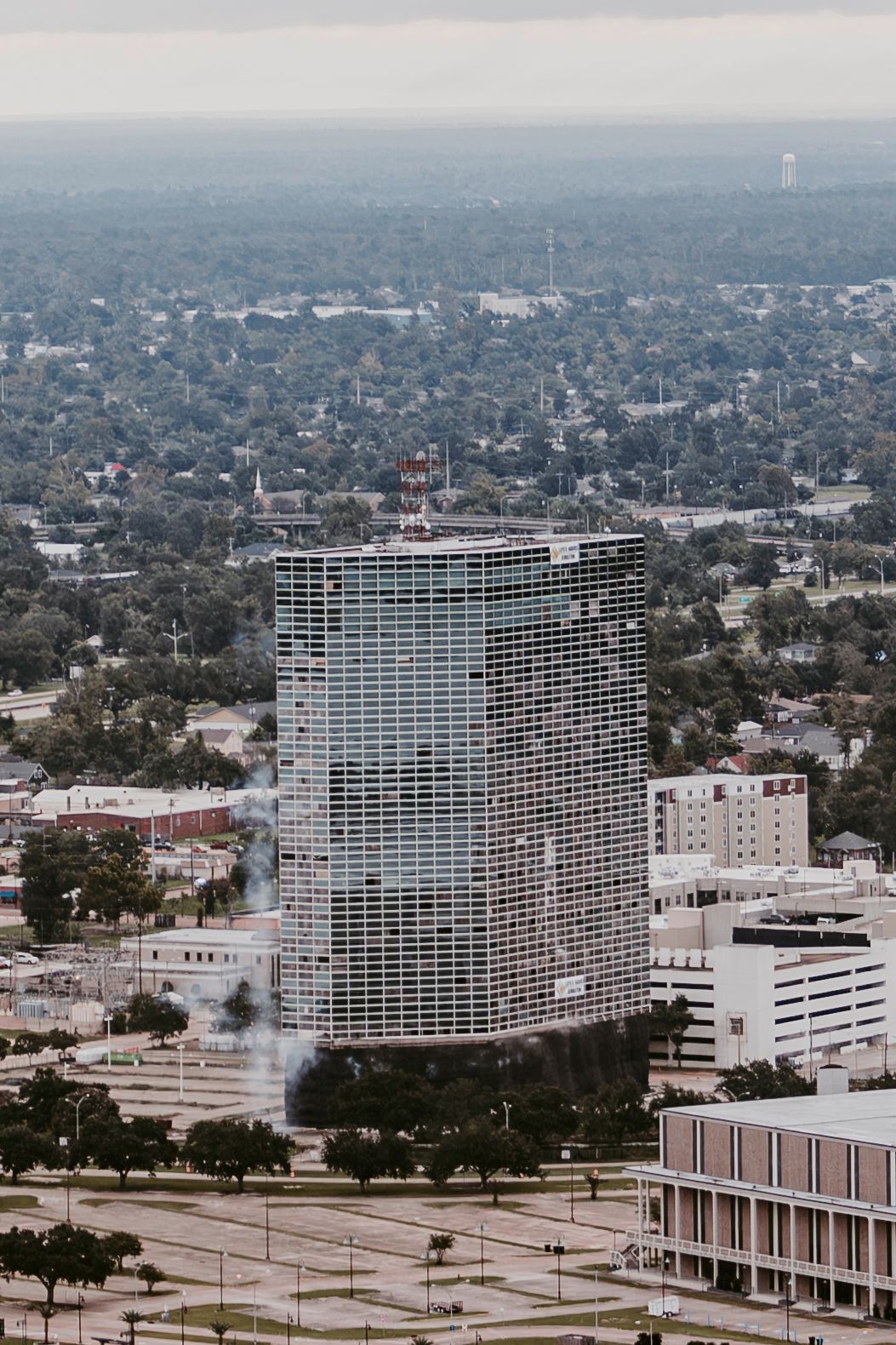 Urban skyline featuring modernist high-rise apartment buildings and surrounding cityscape.
