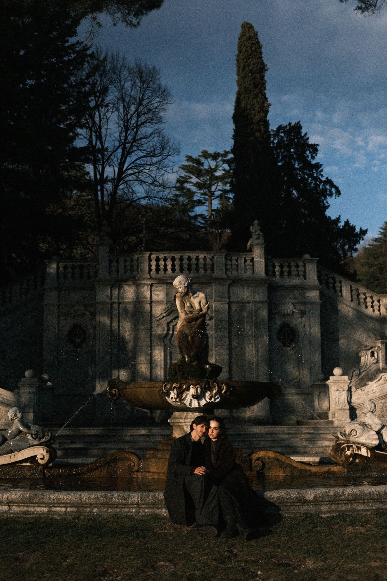 Dramatic sequence of silhouettes against a historic stone building at dusk with moody lighting and architectural details.