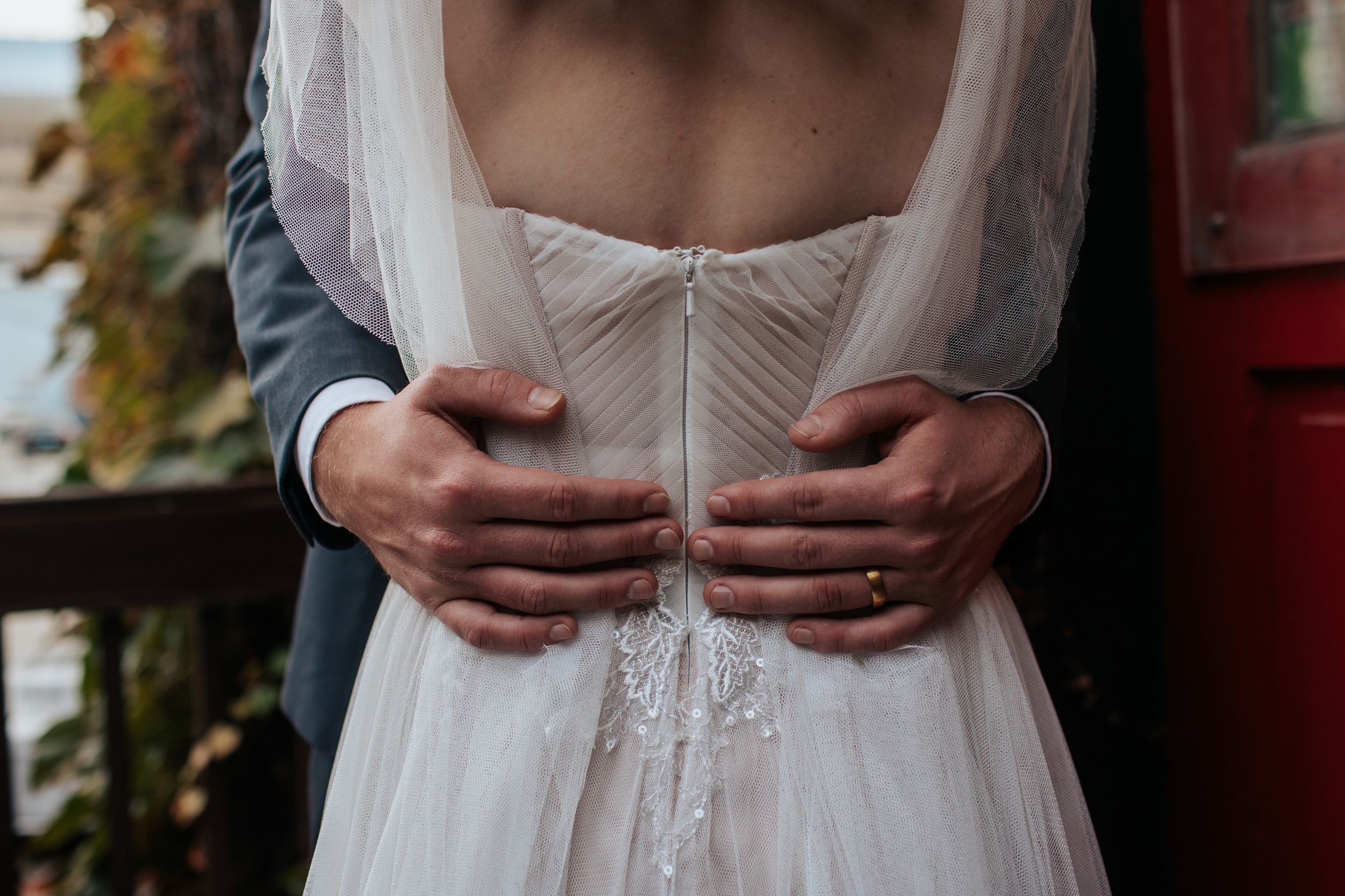 A series of close-up shots showing details of a white wedding dress with delicate lace and fabric details.