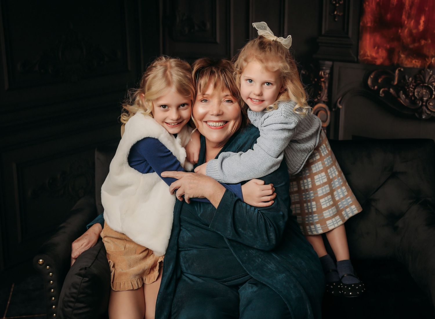 A series of candid family photos showing warm embraces and joyful moments together in a dark room setting.