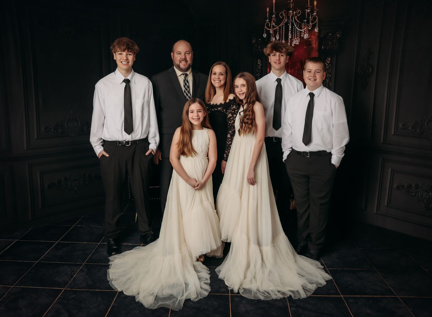 A series of black and white wedding photos showing couples and wedding party members posing in formal attire.