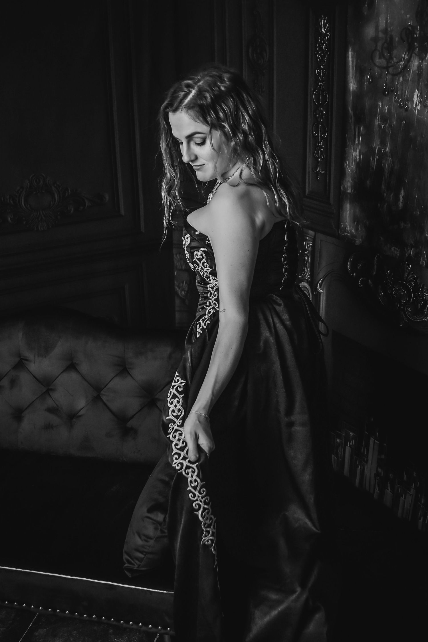 A black and white portrait series showing a figure in a dark dress against a moody, textured background.