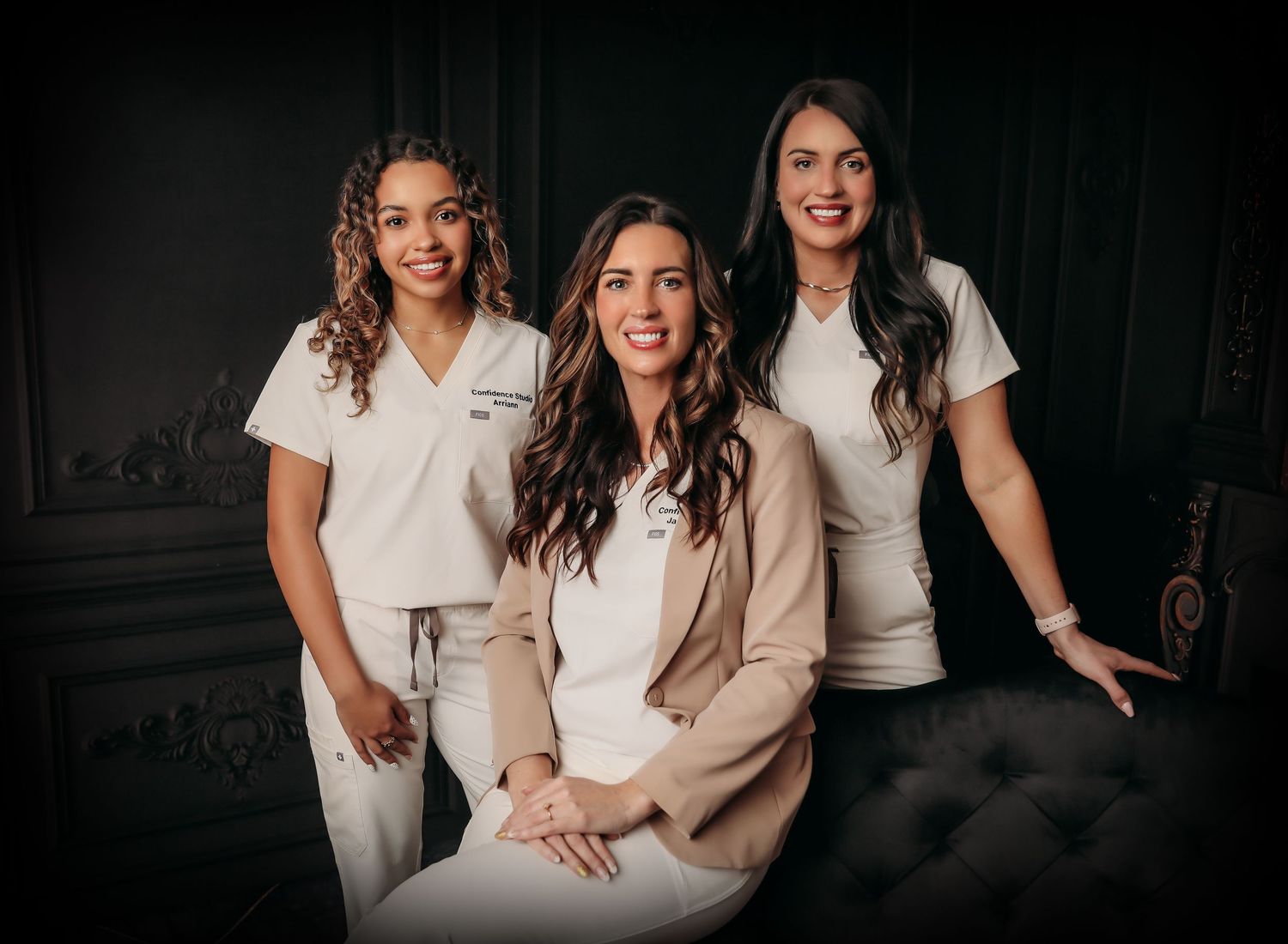 A series of dark moody professional photographs showing people in white and beige outfits sitting together on a couch.