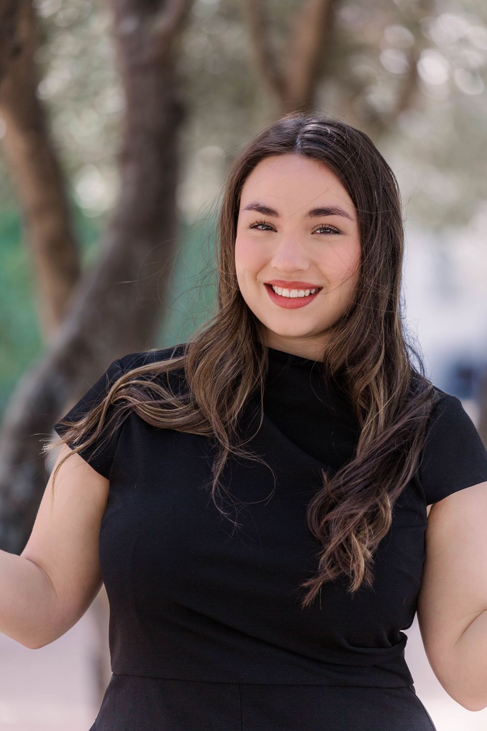 Outdoor portrait series showing a woman in a black top smiling warmly in a natural setting with trees.