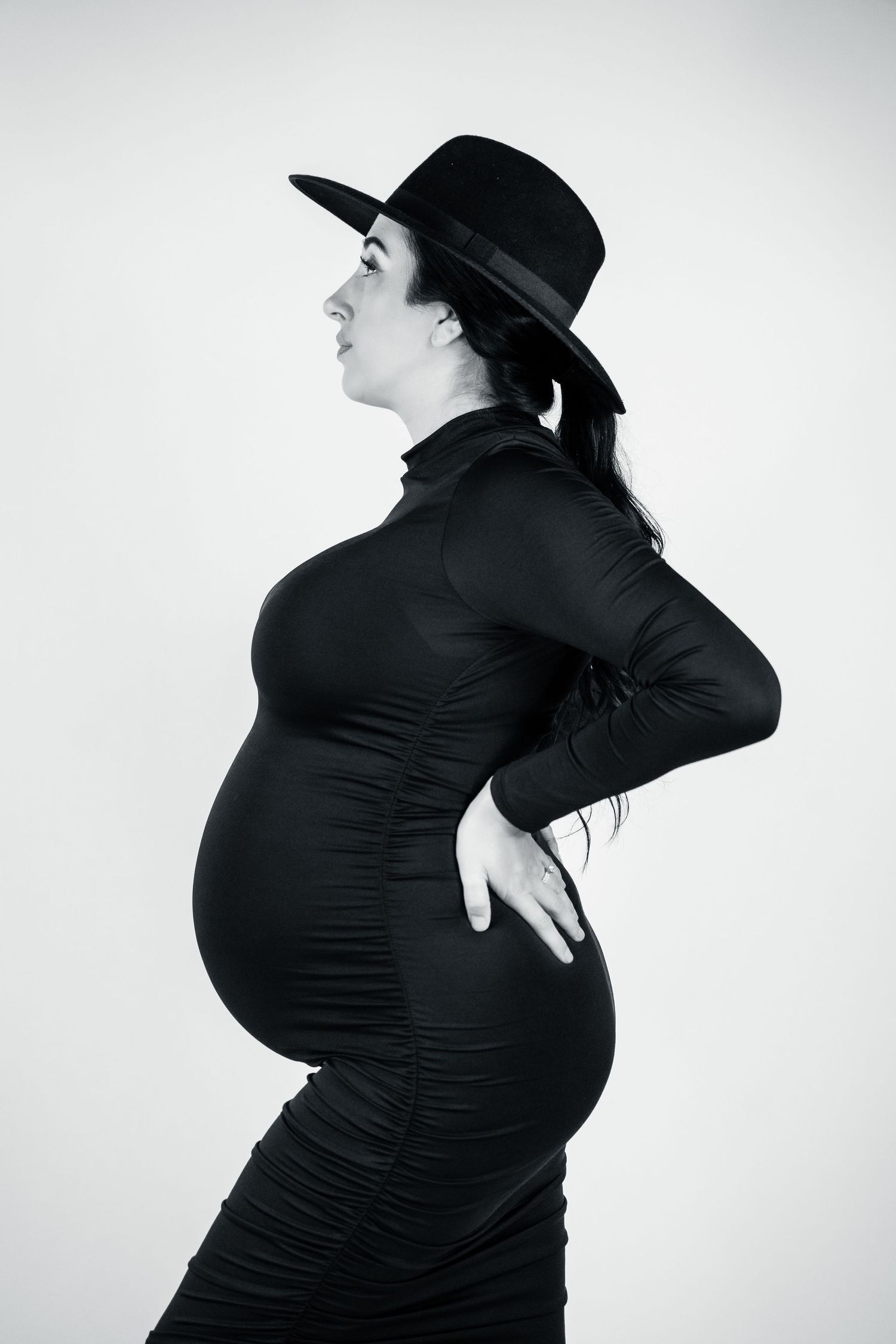 Series of black and white artistic silhouettes showing a pregnant woman in profile.