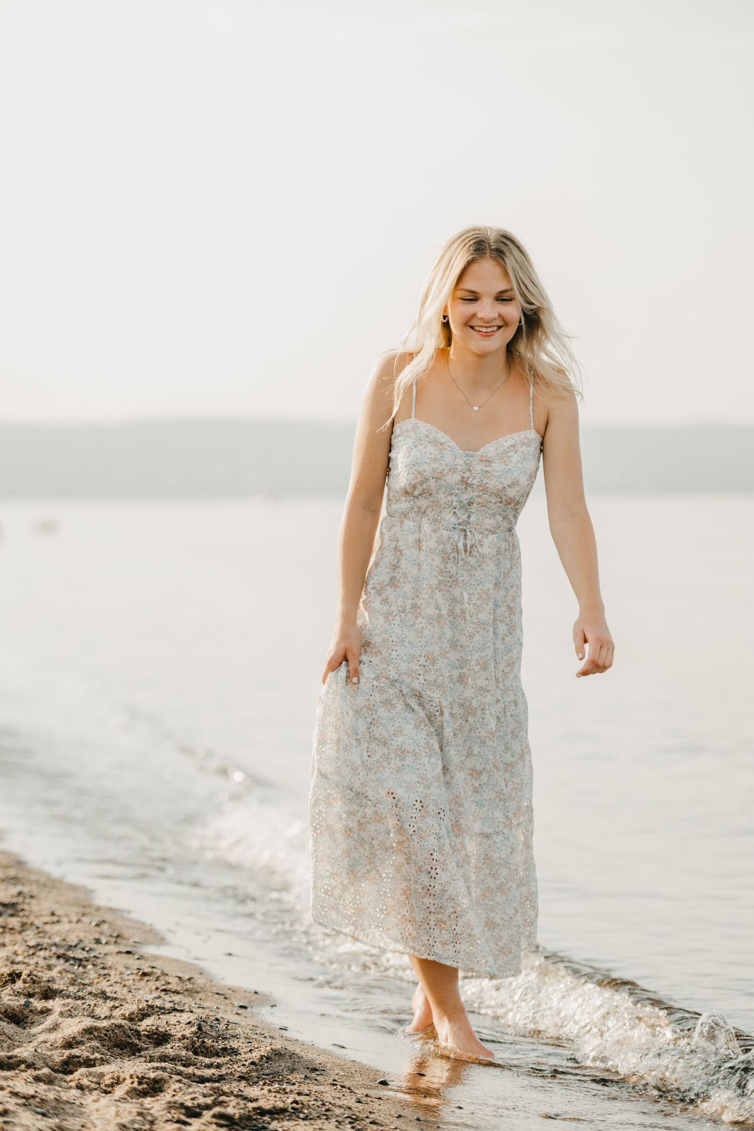 senior grad pictures, sunrise lake Superior, Duluth Minnesota, girl walking by Lake Superior