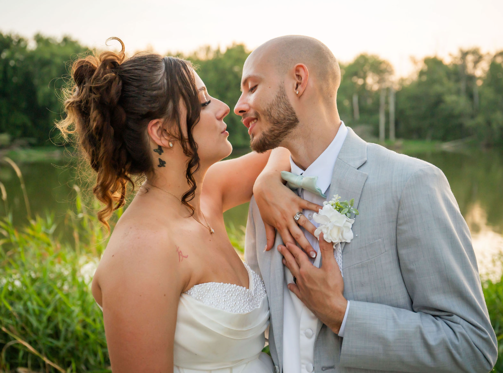 A loving couple shares a tender moment in their first dance on their wedding, with the groom wearing a military dress uniform.