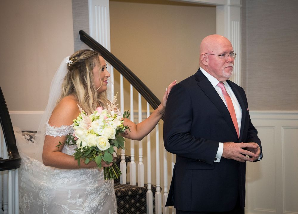 Wedding sequence showing bride and father sharing first look moments before walking down the aisle.