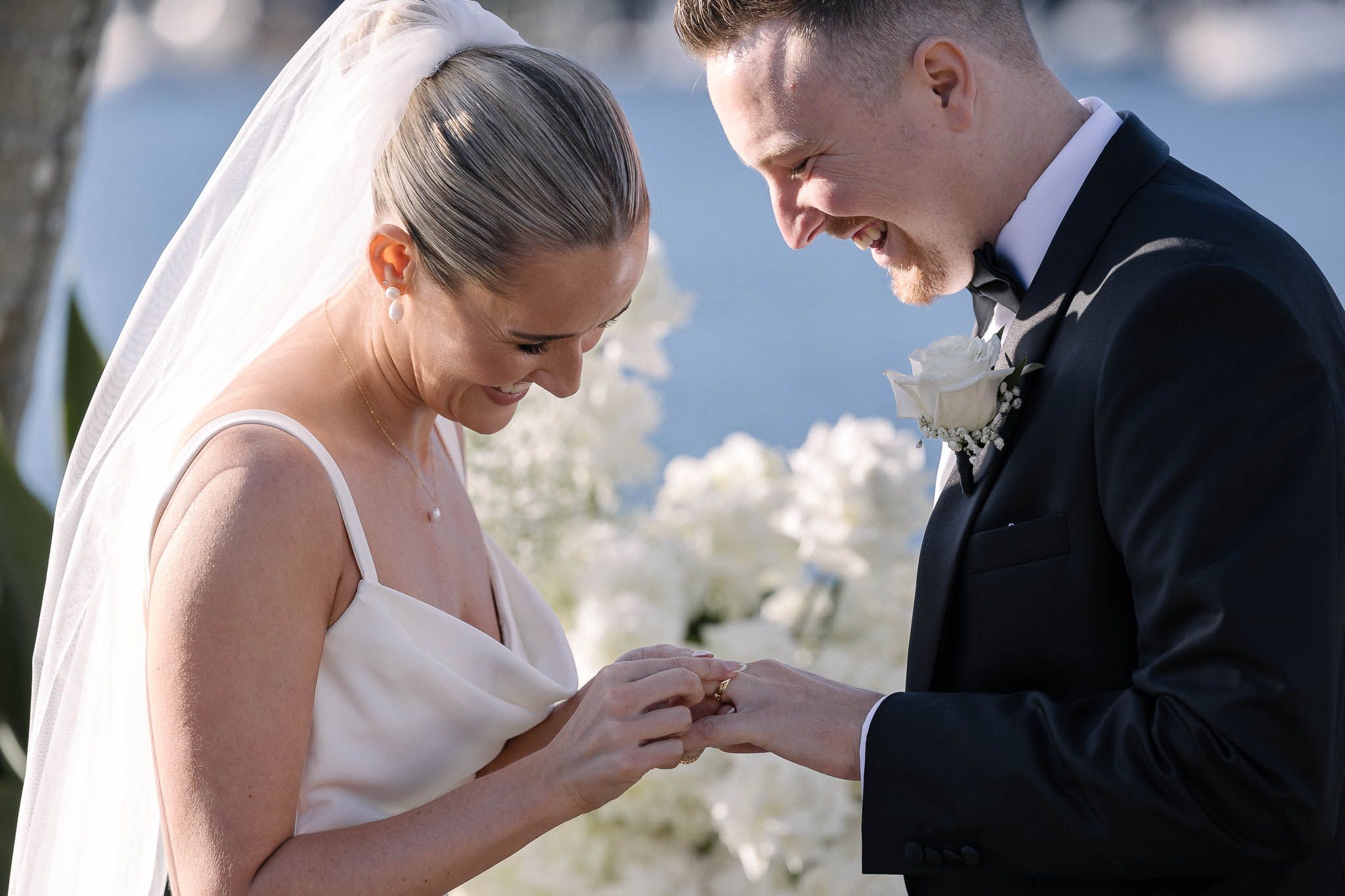 bride and groom putting wedding rings on and smiling at pasadena sydney
