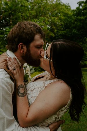 Artistic wedding portrait capturing intimate moment between couple in outdoor setting.