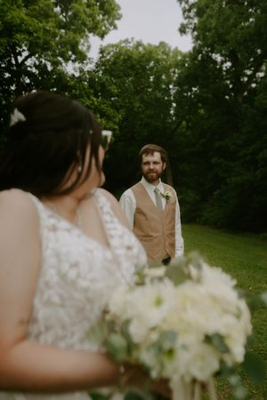 A wedding couple shares an intimate moment during their outdoor photo session.