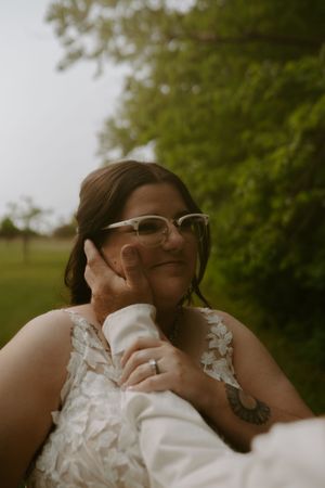 A candid moment captured of the bride during the outdoor wedding celebration.