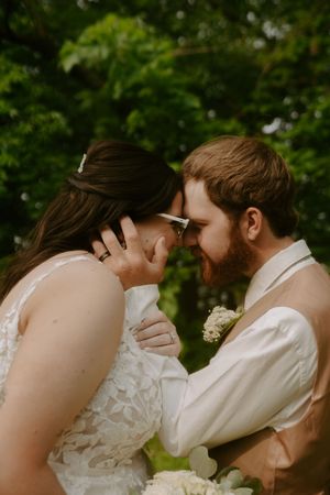 Artistic wedding photography sequence capturing a loving embrace in a natural setting.