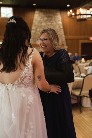 Wedding reception scene showing dance floor moments in a rustic venue.