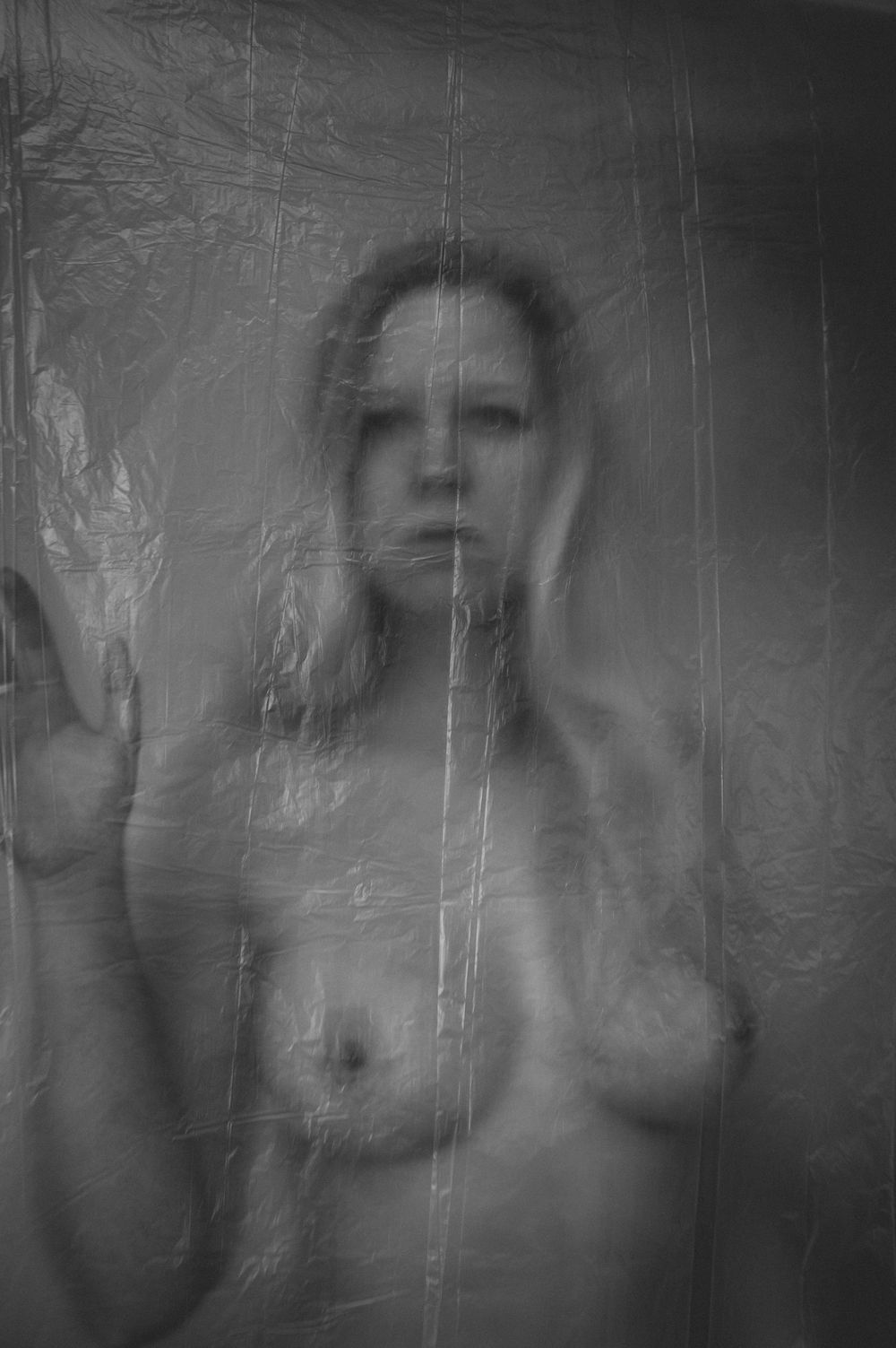 Artistic black and white photograph captured through textured translucent material creating an ethereal effect.