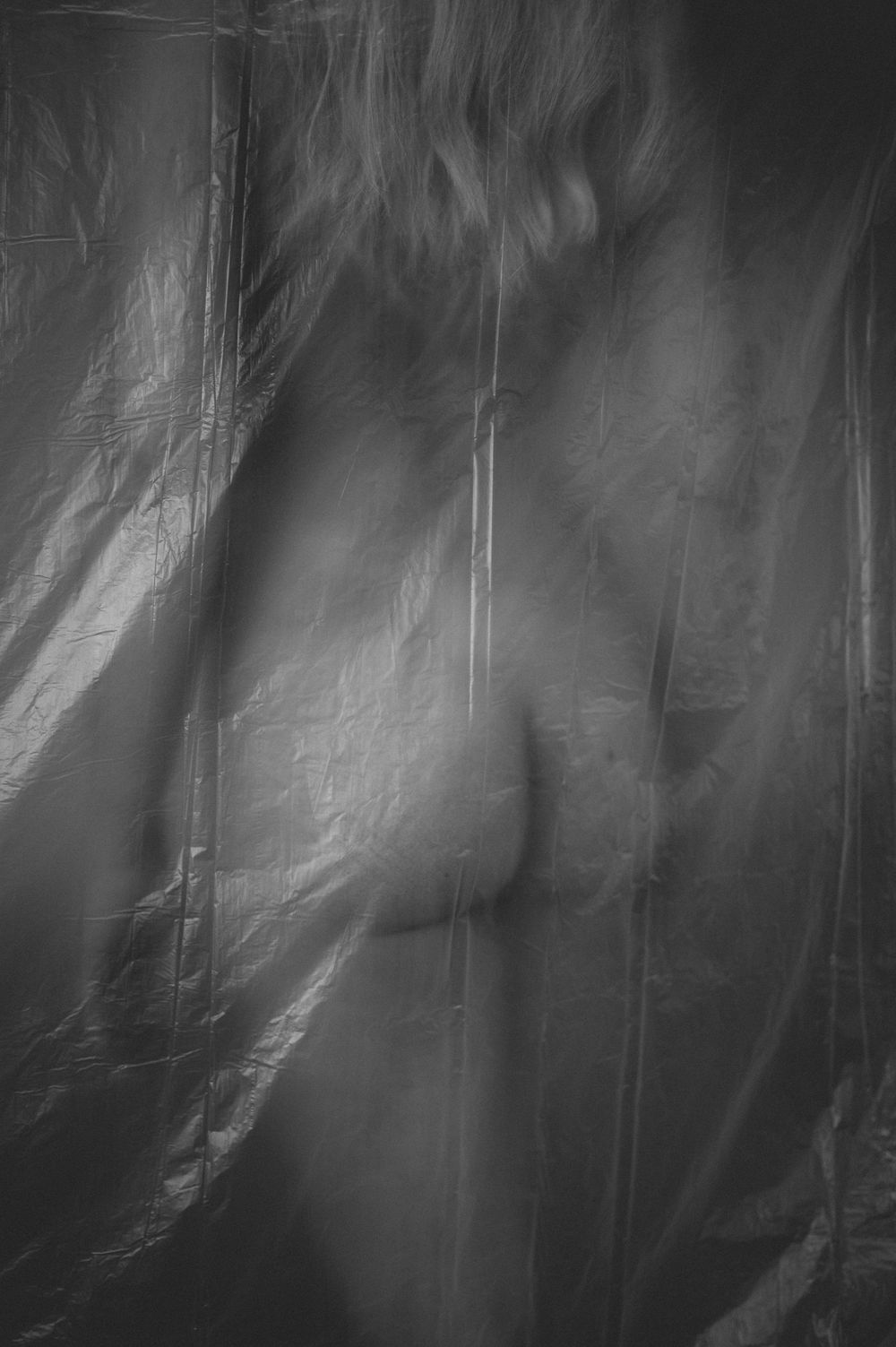 An abstract black and white motion blur pattern creates a ghostly ethereal effect.