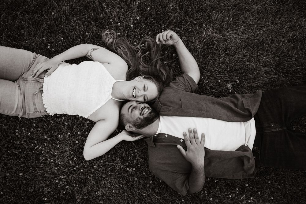 A black and white photo sequence shows a playful person rolling down a grassy hill in casual attire.
