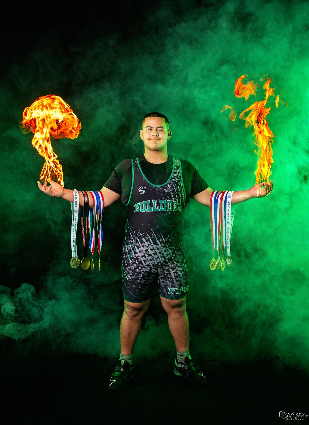 A figure stands in dramatic green smoke holding flaming medals while wearing athletic gear in a progressive photo sequence.