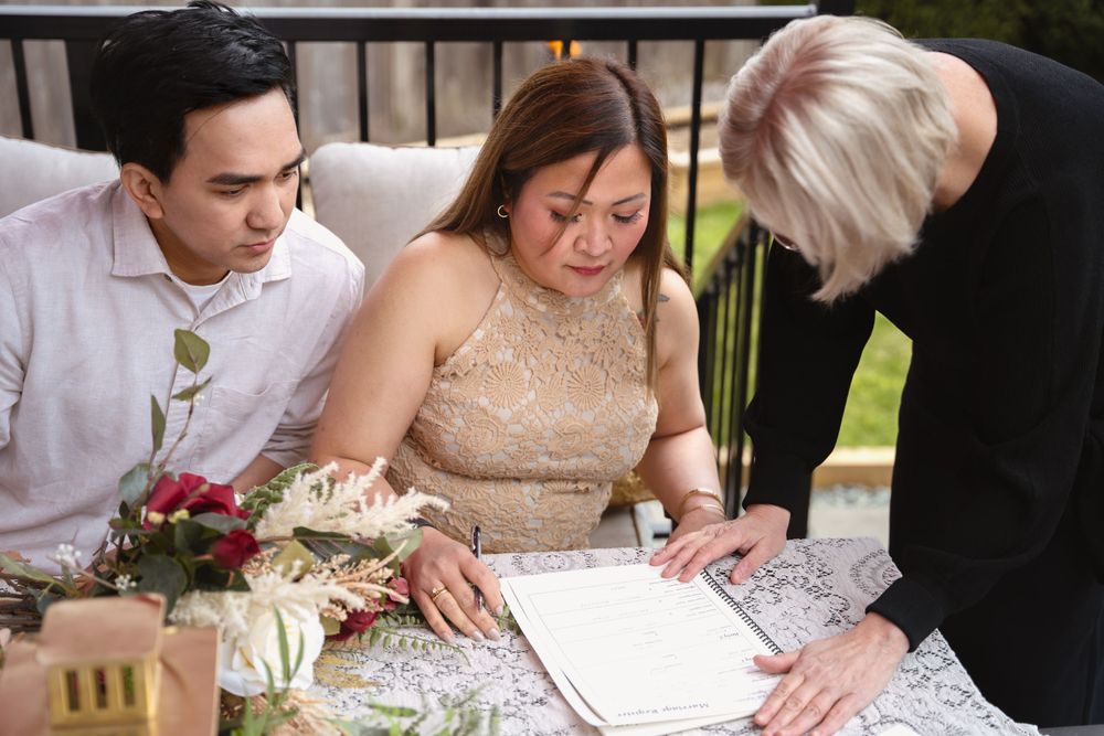 Signing of official documents at an elegant wedding reception.