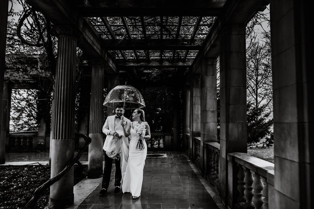 A long covered walkway with ornate wooden beams and traditional Japanese architecture extends into the distance.