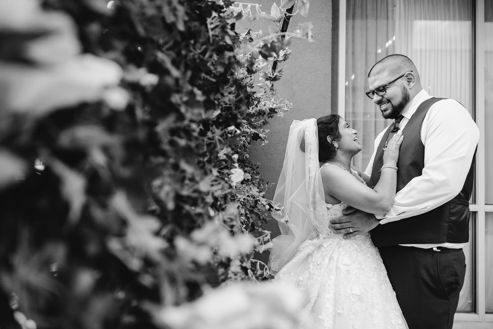 Black and white wedding ceremony photos showing intimate moments between the couple and their guests during celebrations.