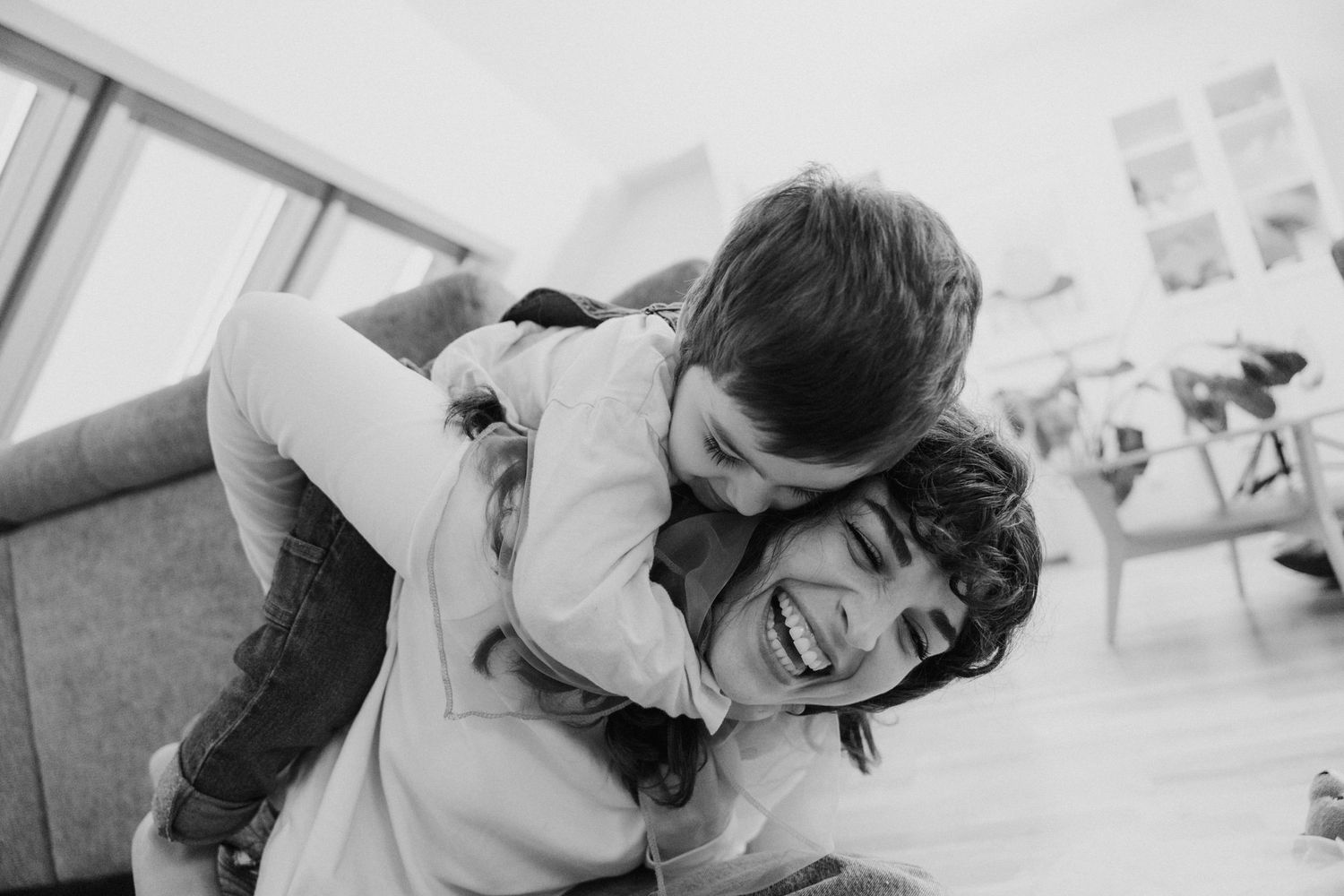 A series of black and white photographs showing two people in joyful embrace and intimate moments together.