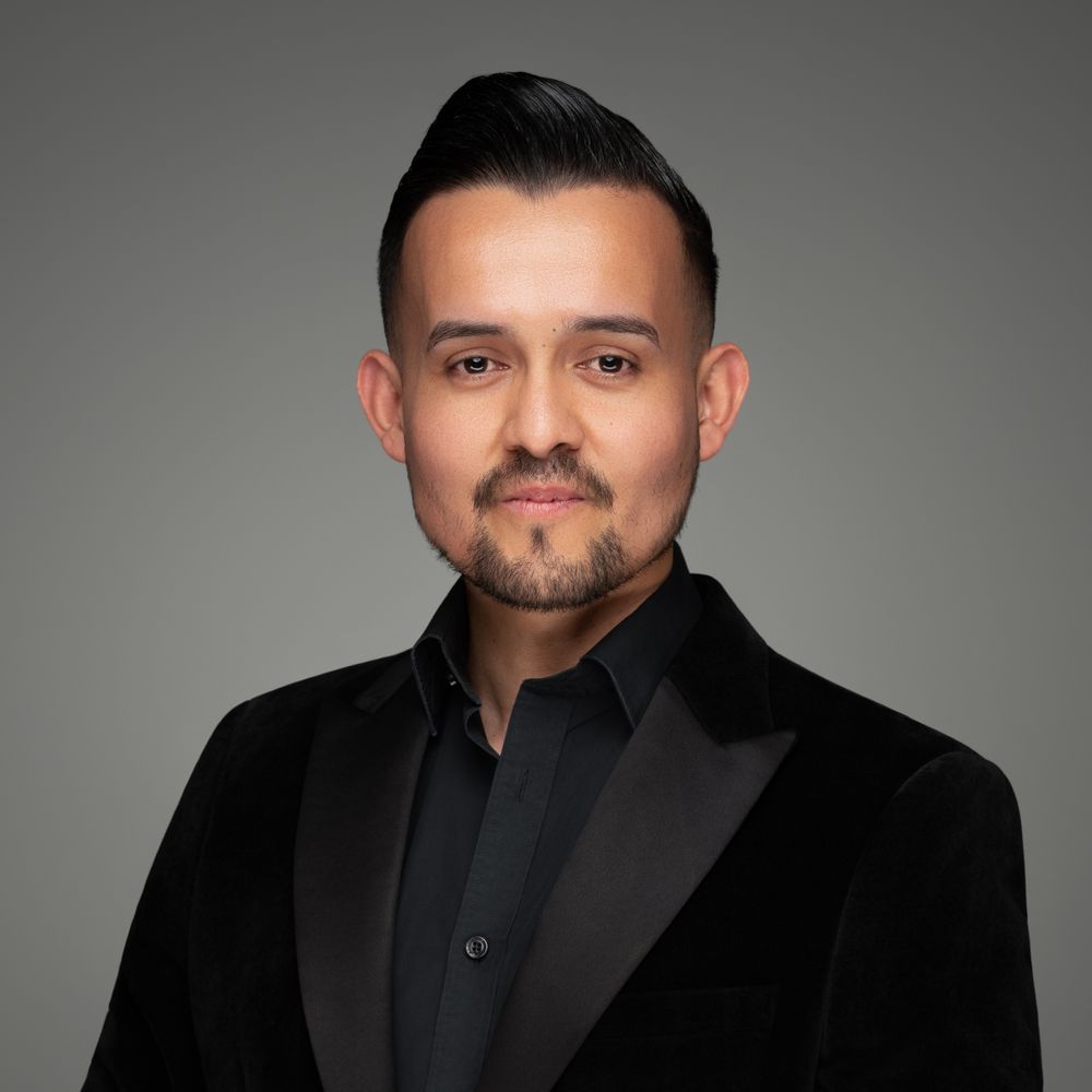 Portrait series showing different angles of a person wearing all black formal attire against a gray backdrop.