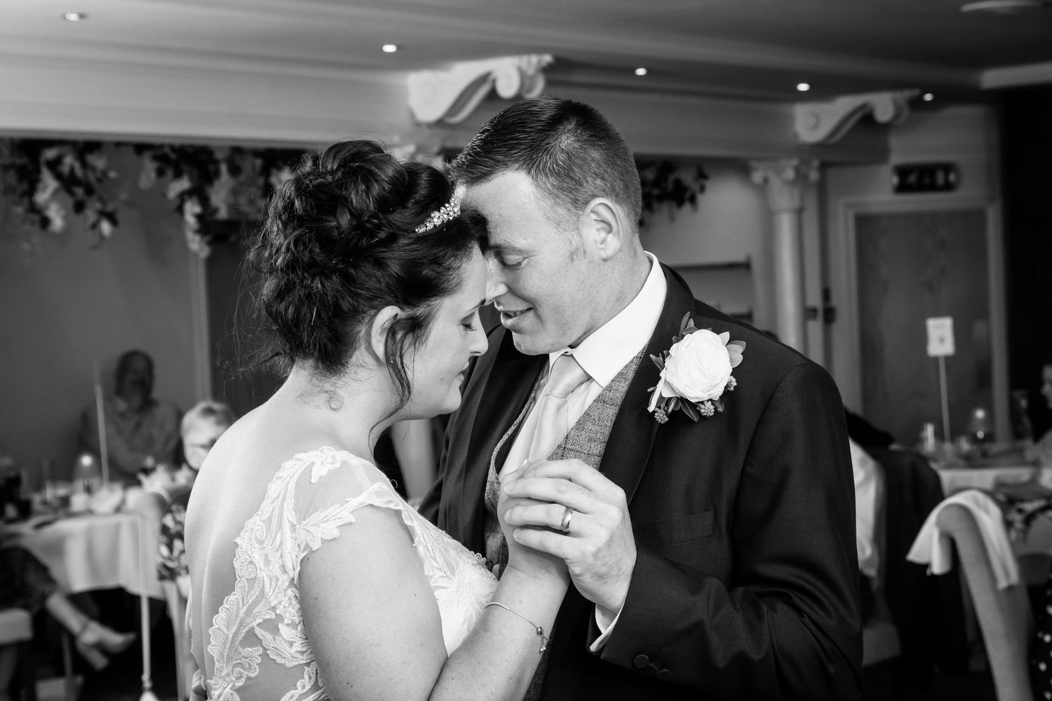 black and white wedding day photograph of a bride and groom holding each other by Michael Pardoe, Cheshire wedding photographer.