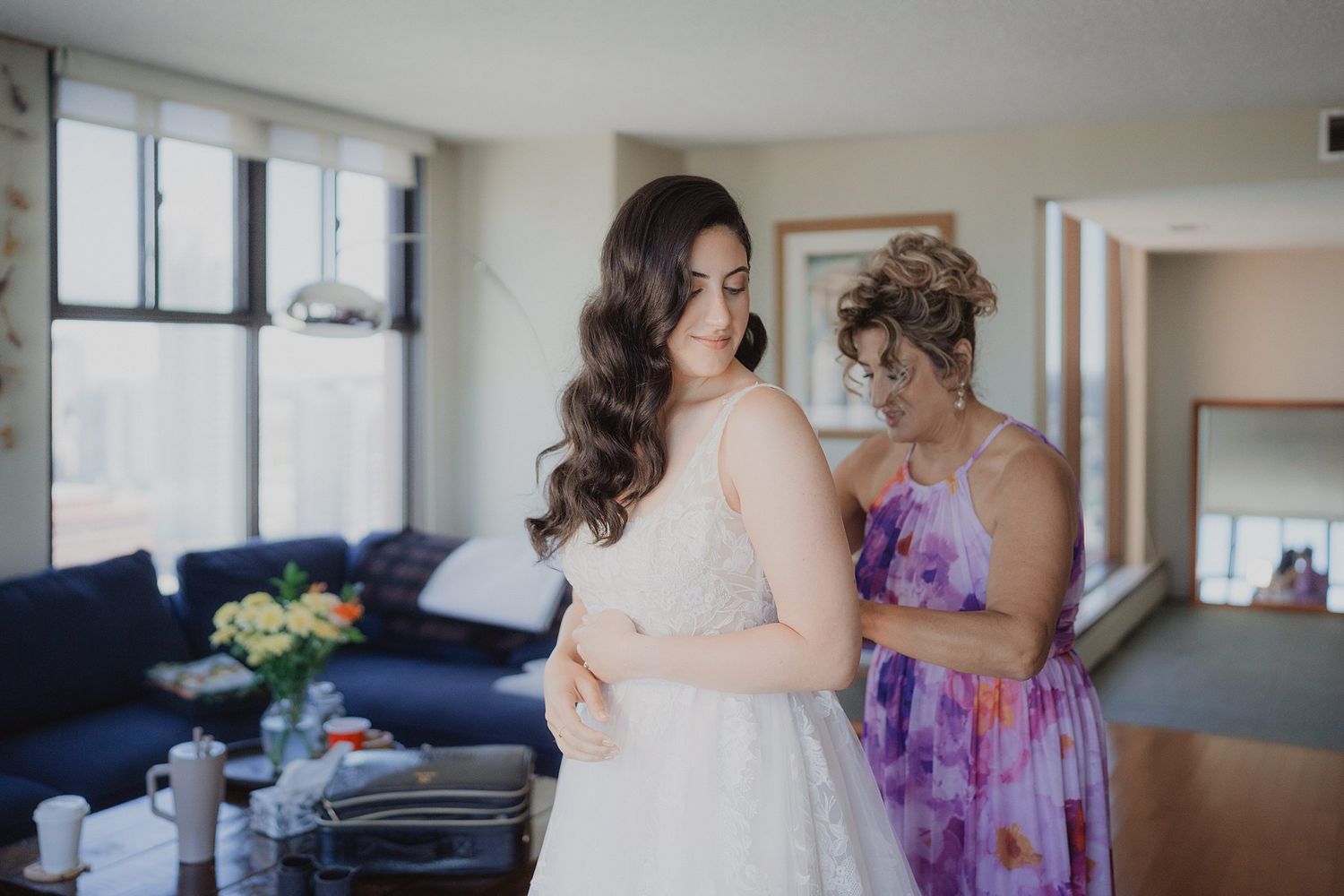 Bridal party sharing joyful moments together in a sunlit room with modern decor.