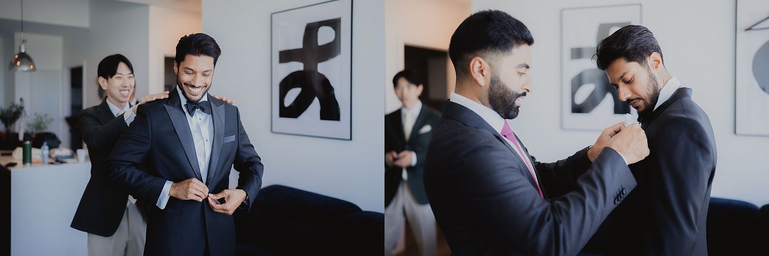 Men in black suits and bowties gathered in room with modern black and white artwork.