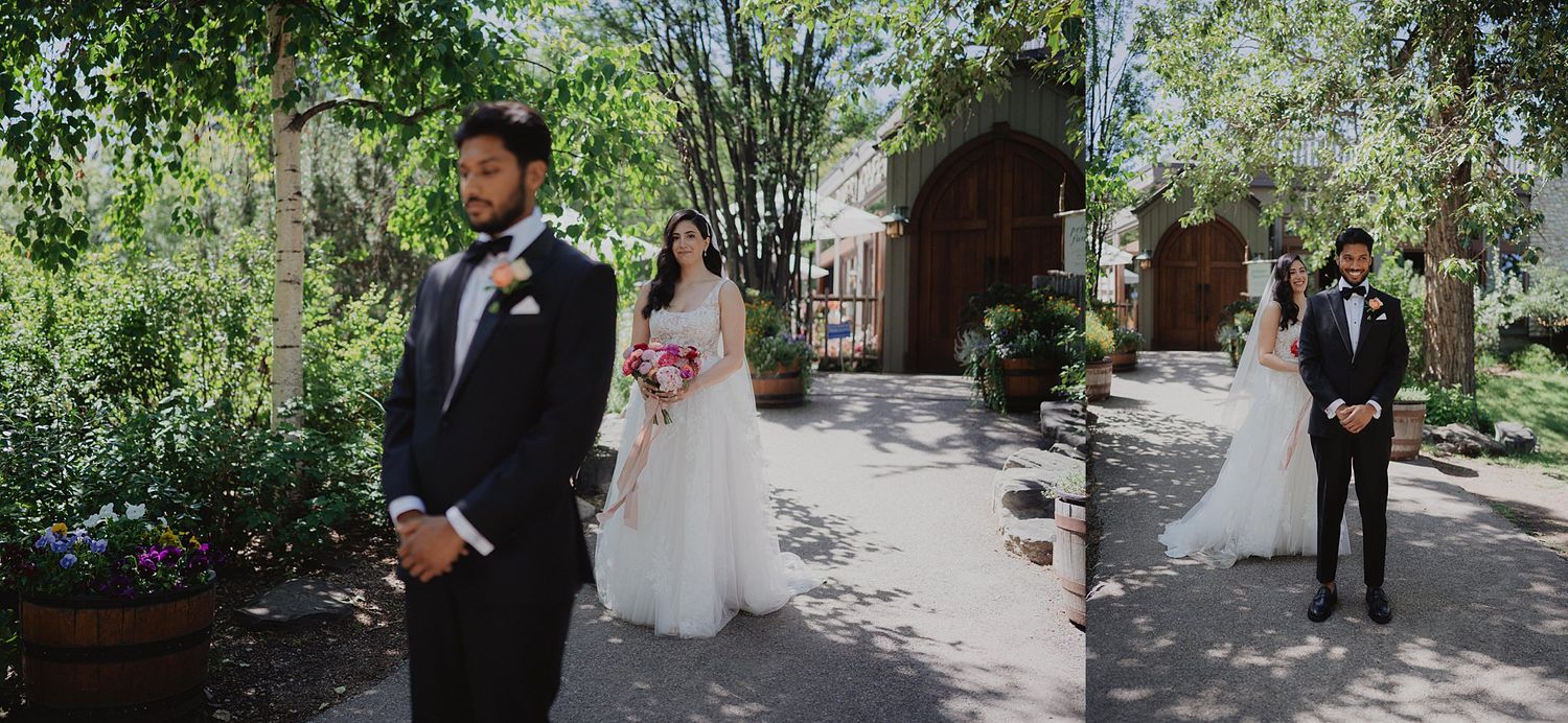 Wedding couple walks through lush garden pathway during outdoor ceremony.