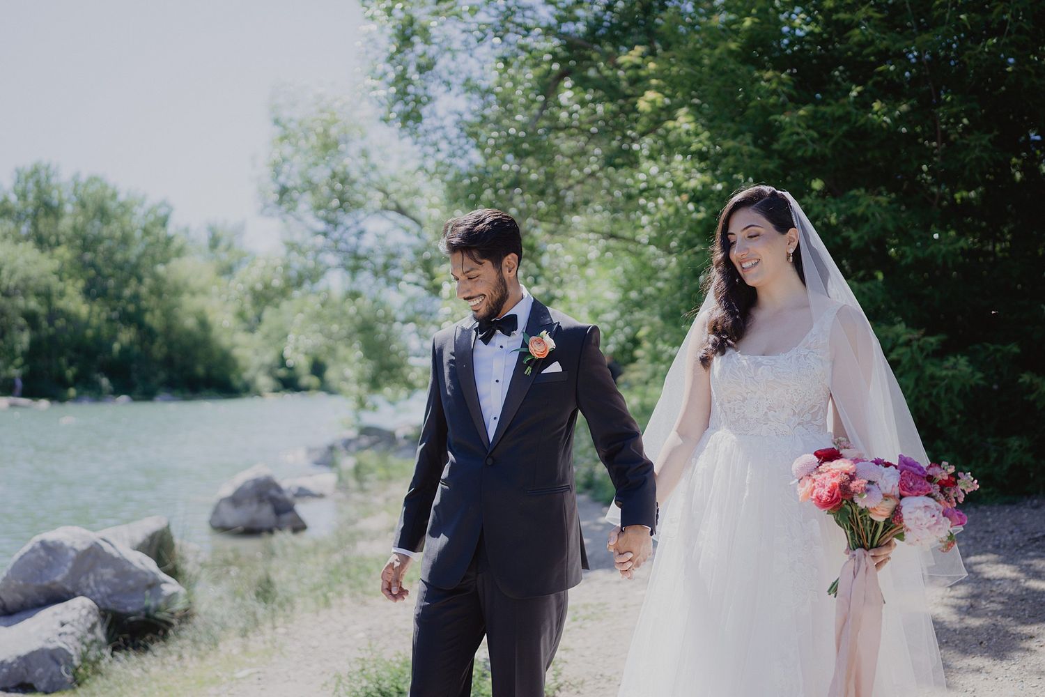 Wedding couple shares intimate moments during their outdoor forest photoshoot with natural greenery backdrop.