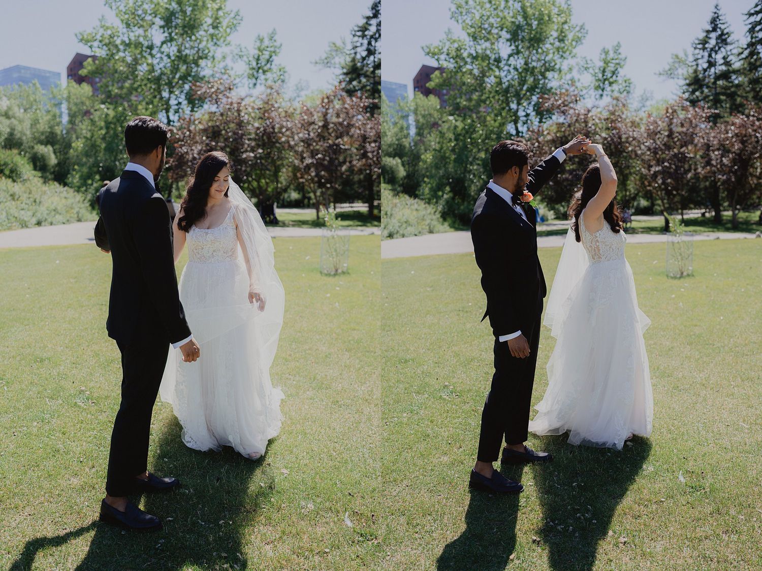 A couple in wedding attire sharing a romantic moment outdoors on a sunny day with trees in the background.