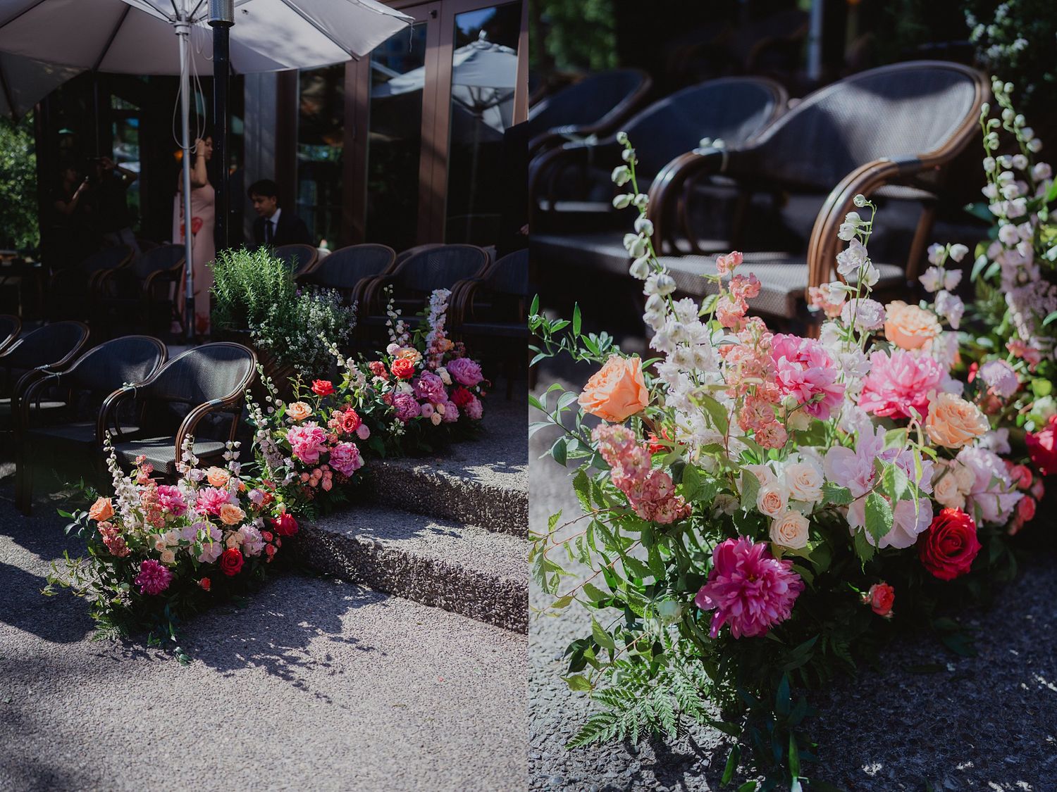 Vibrant pink and coral floral arrangements line a rustic outdoor wedding venue.