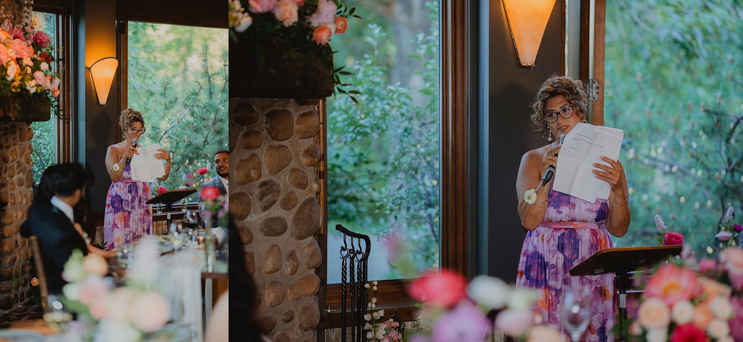 Intimate wedding reception setting with soft lighting, stone walls and colorful floral centerpieces.