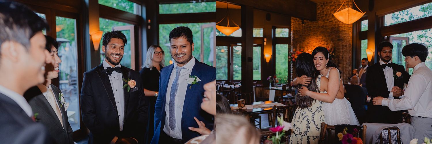 Evening wedding reception with guests mingling in a warmly lit indoor space with wooden beams.