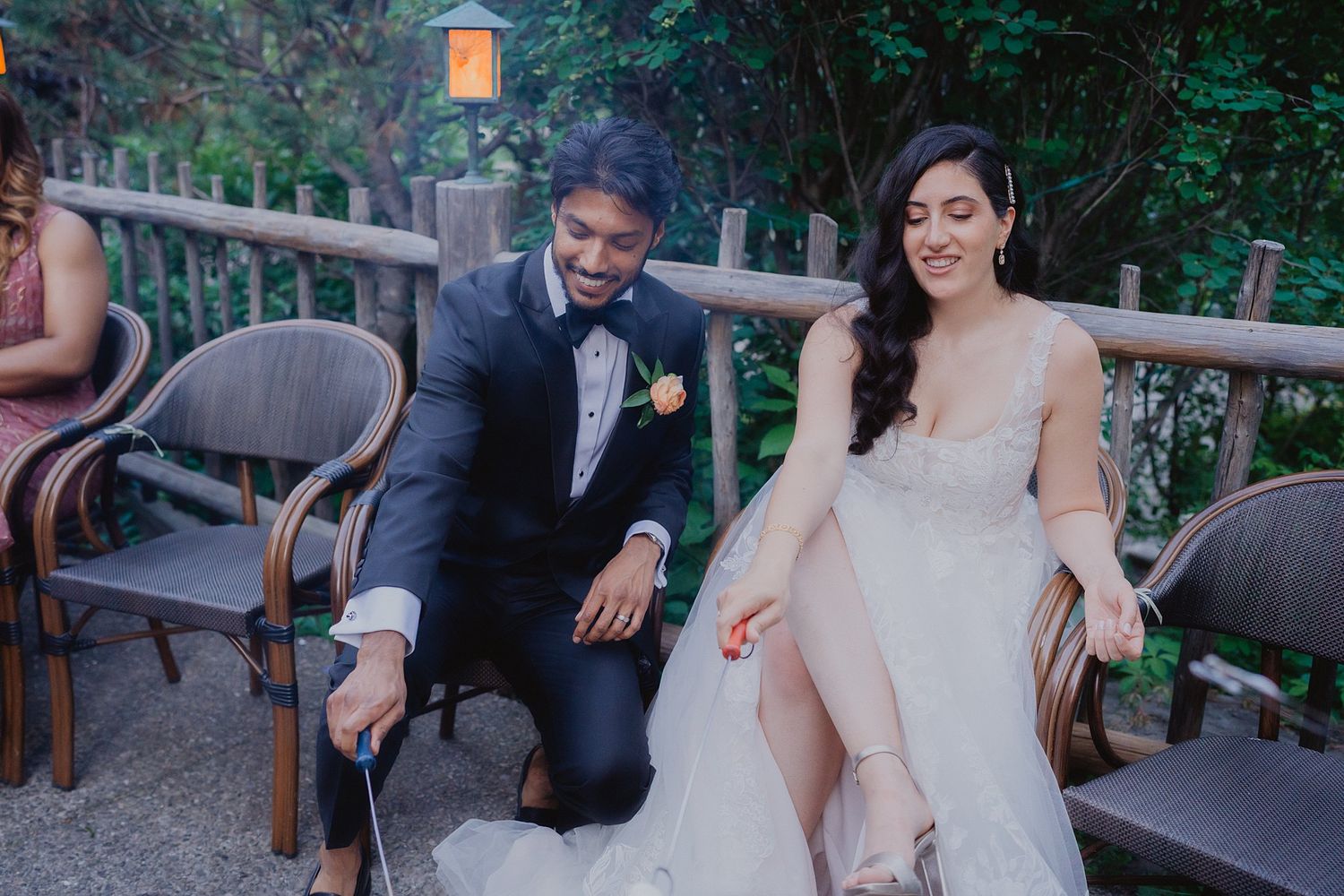 Couple sharing a romantic moment on outdoor garden furniture during their wedding celebration.