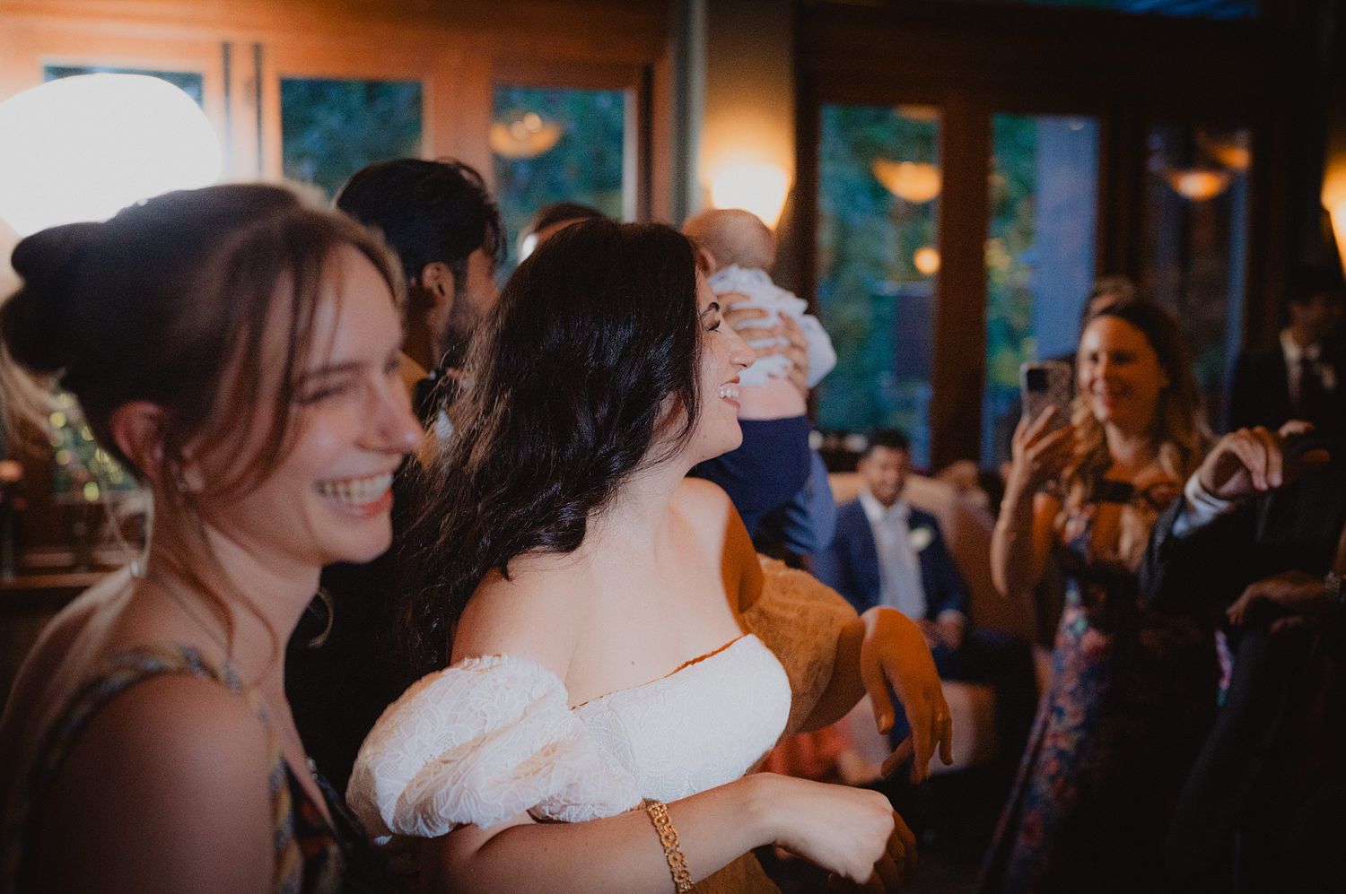 A collection of candid moments from a wedding reception showing guests dancing and celebrating in an indoor venue.