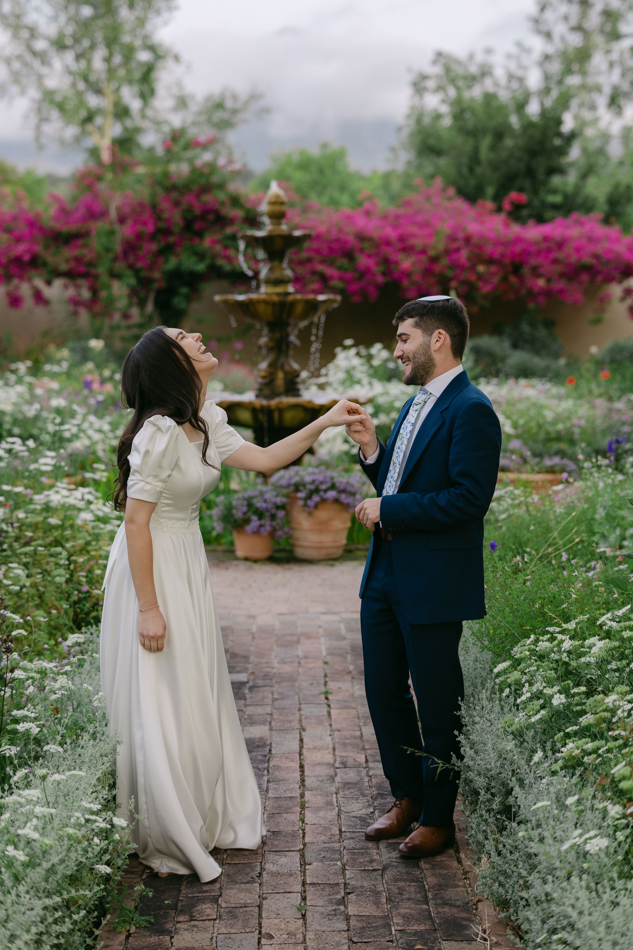 A romantic dance sequence captured in a garden with blooming flowers and brick pathways.