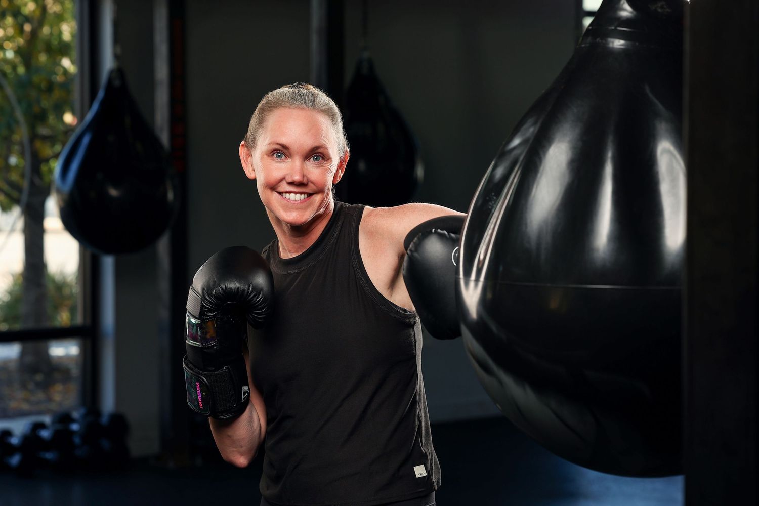 Picture of woman boxing. Professional fitness photography by Boswell Photography. Photo taken in Rise Boxing Gym in Park City Utah.