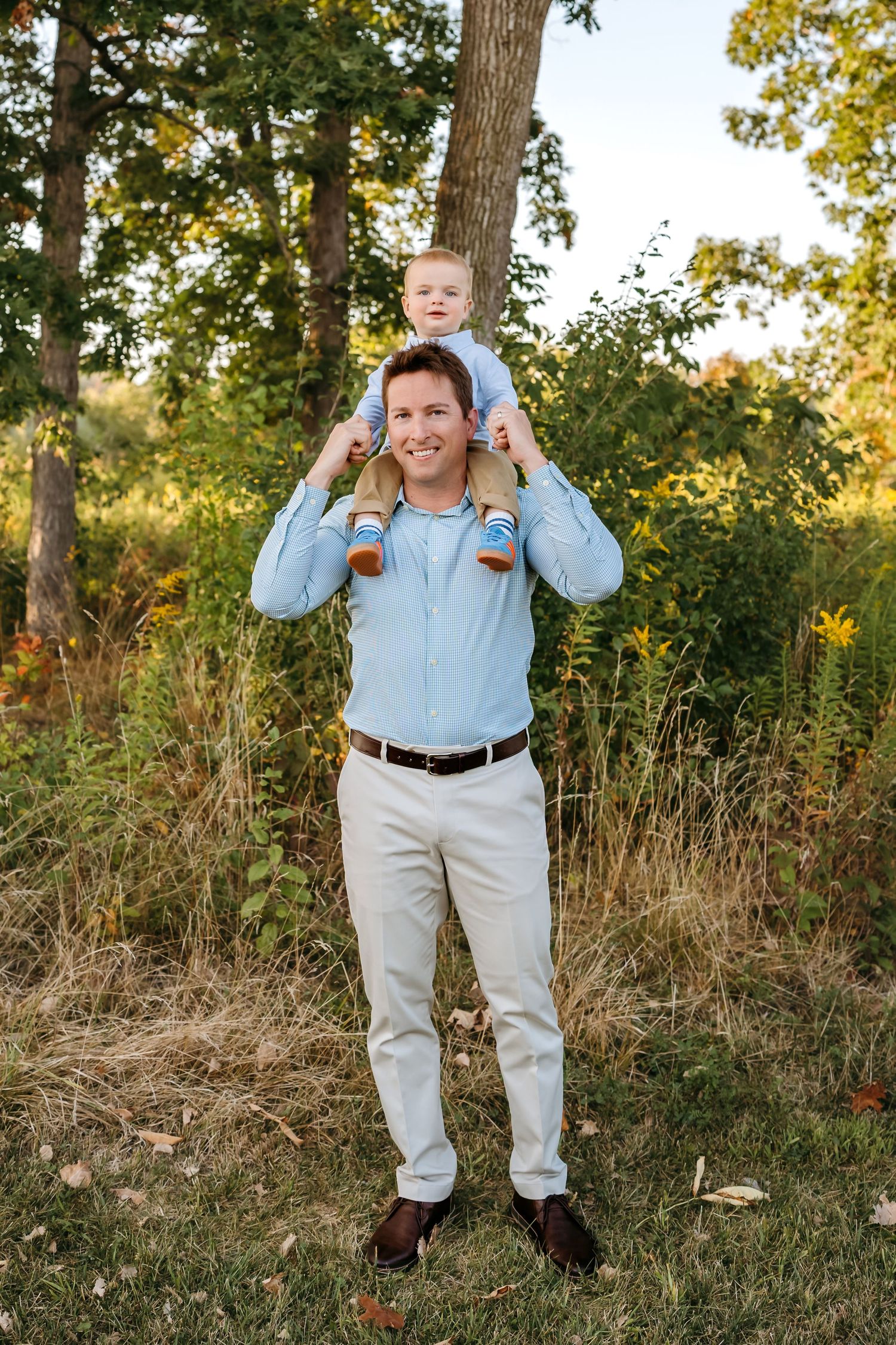 A series of playful outdoor portrait shots in a natural setting with fall foliage and trees in the background.