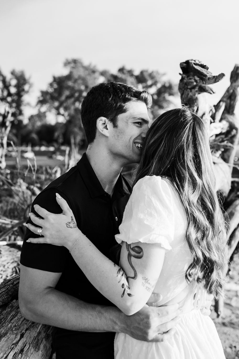 A romantic black and white photo series showing tender moments between a couple outdoors.