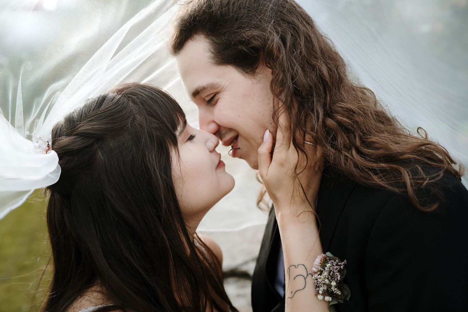 Romantic close-up shots of couple sharing intimate moments with veil flowing in wind.