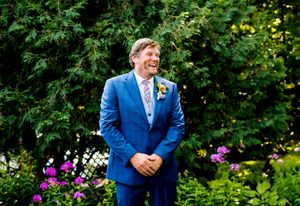 An outdoor wedding celebration with bright flowers and natural garden scenery.