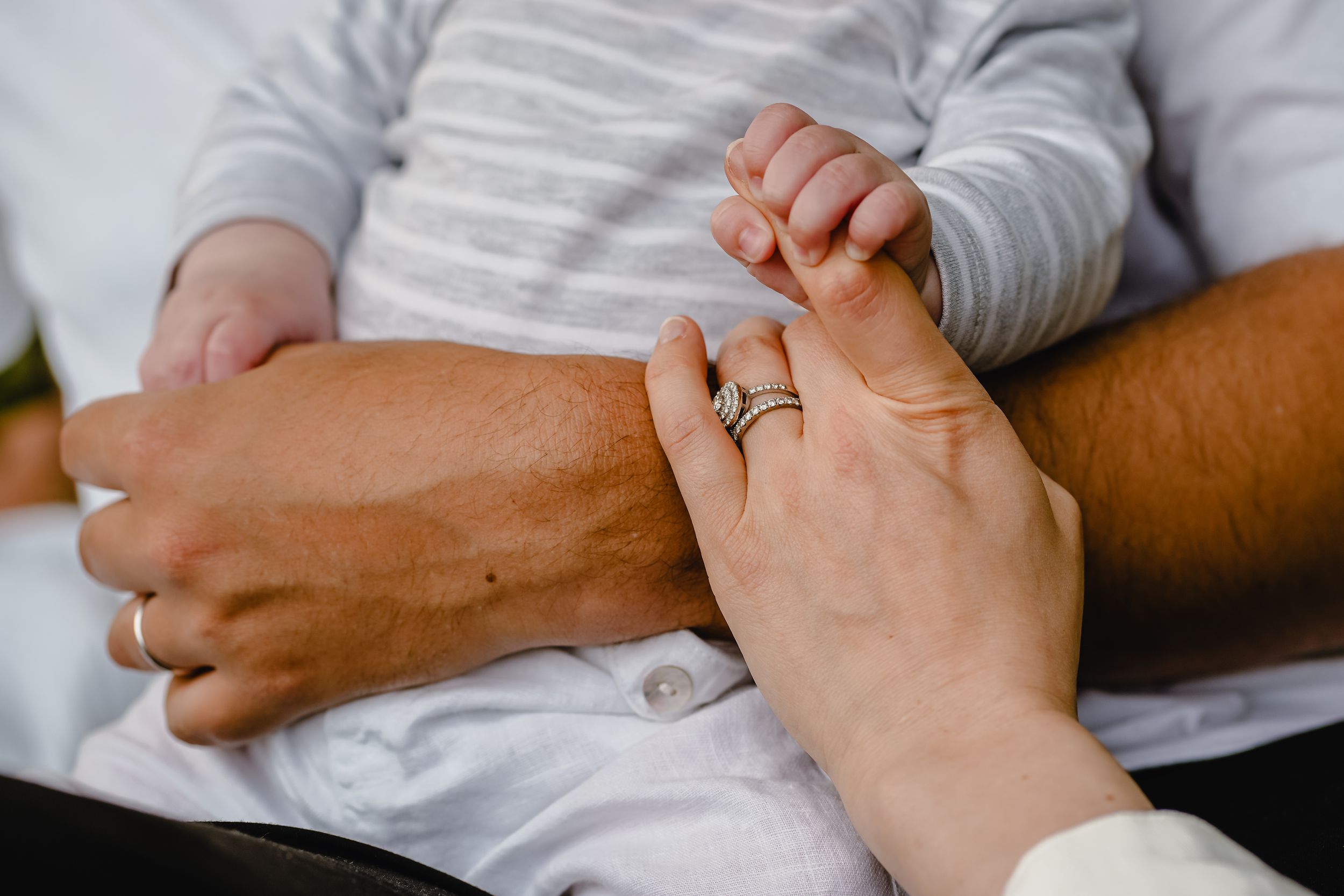 Close-up shots of hands intertwined showing intimate connection and tenderness.