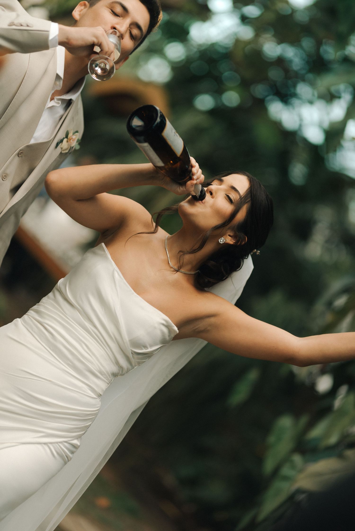 Celebratory champagne moment at outdoor wedding reception.