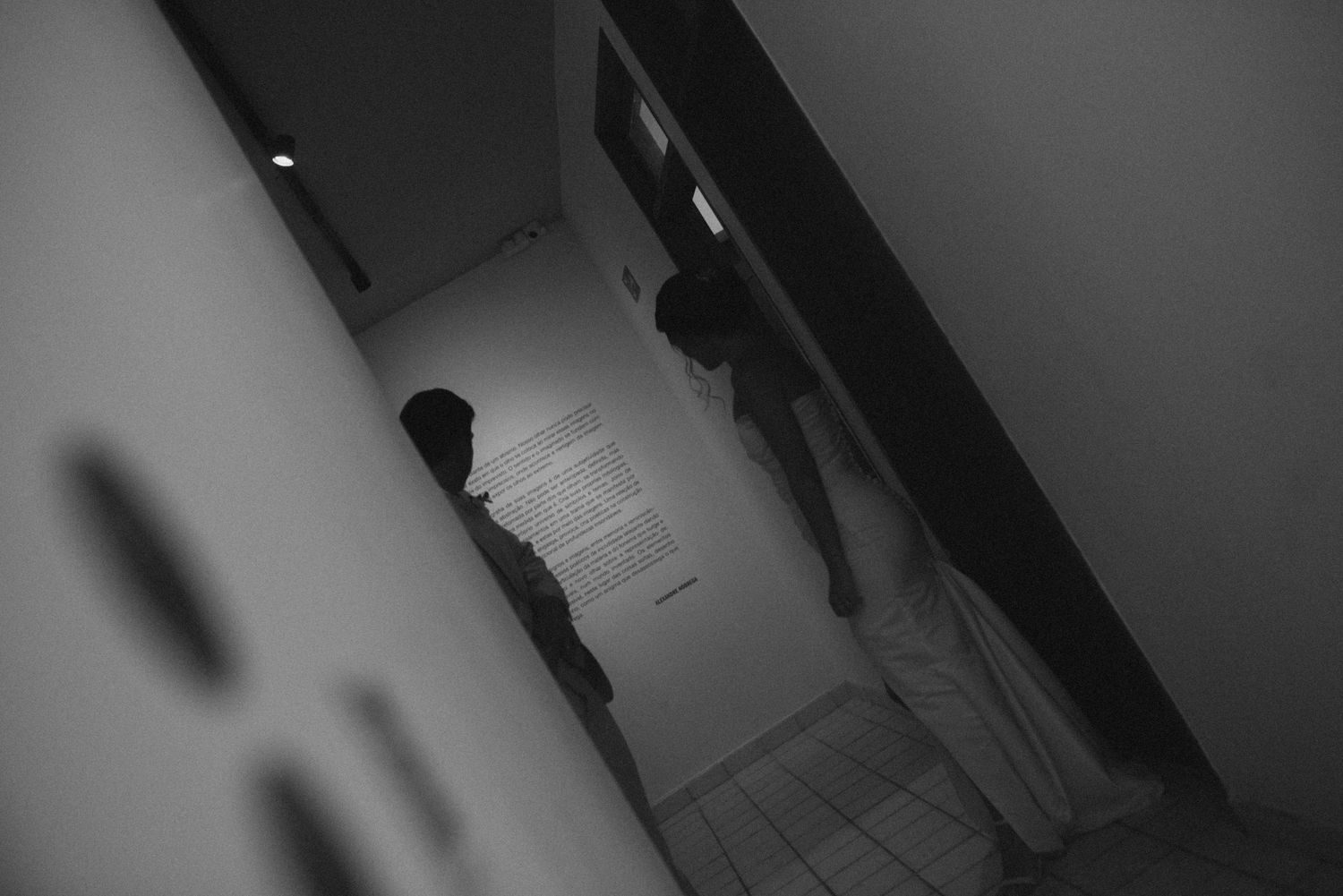 A silhouetted couple in a dark hallway creating a dramatic wedding moment.